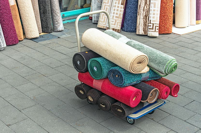 Carpet rolls transported on a platform trolley